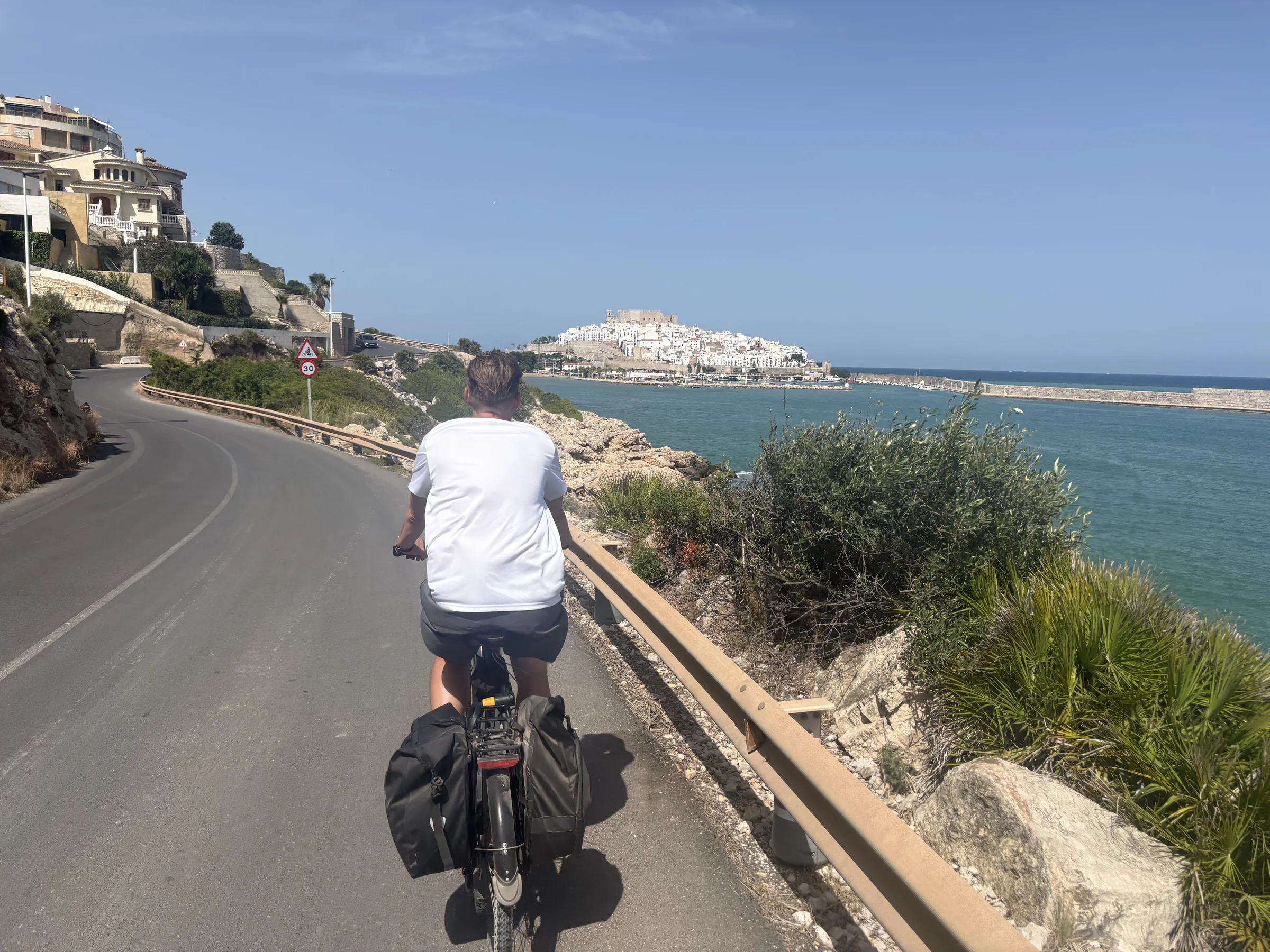 Solo e-bike rider on the open Costa Azahar coast near Valencia.