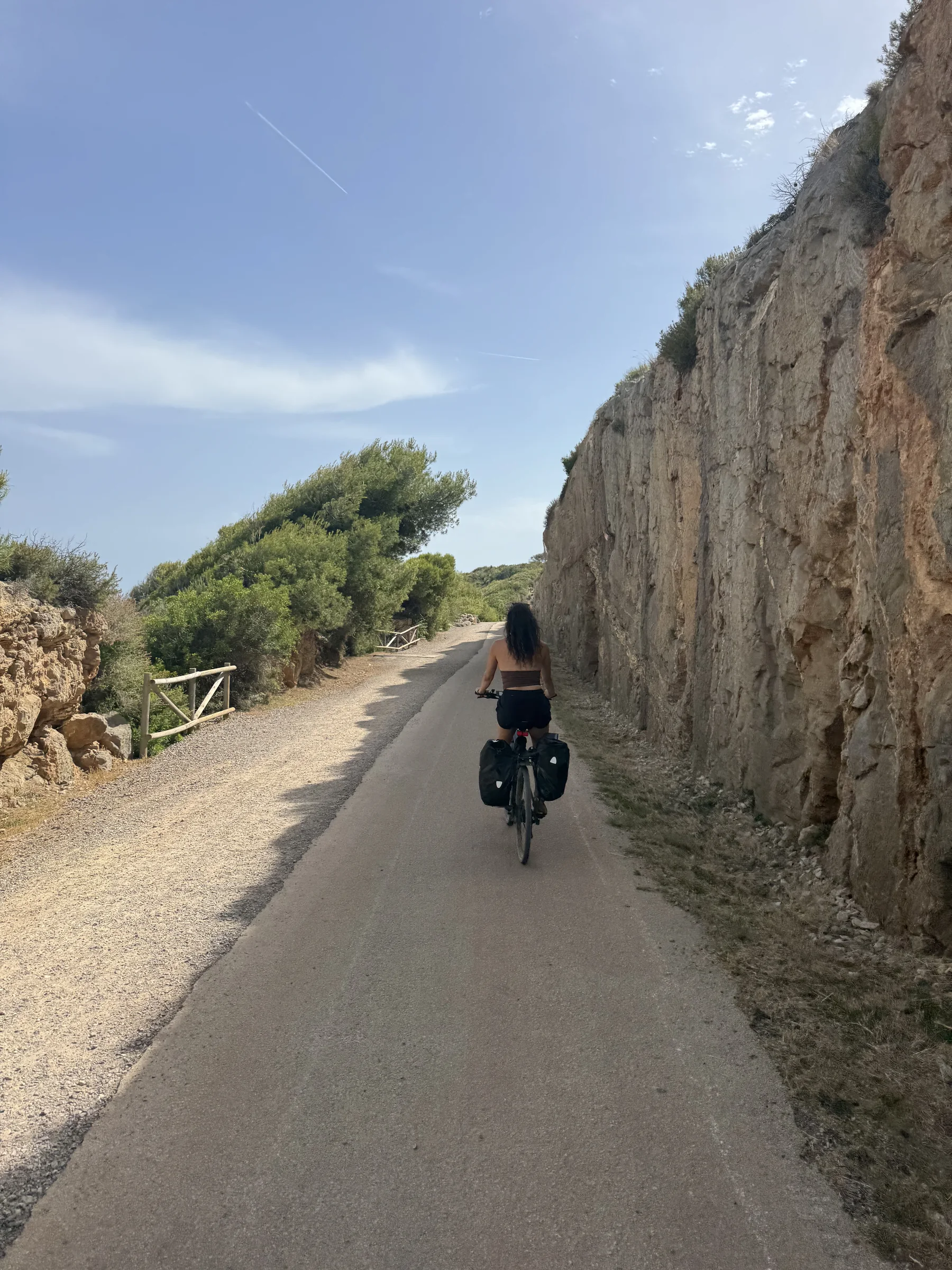 E-bike rider on a quiet Costa Azahar coastal track toward Peñíscola.
